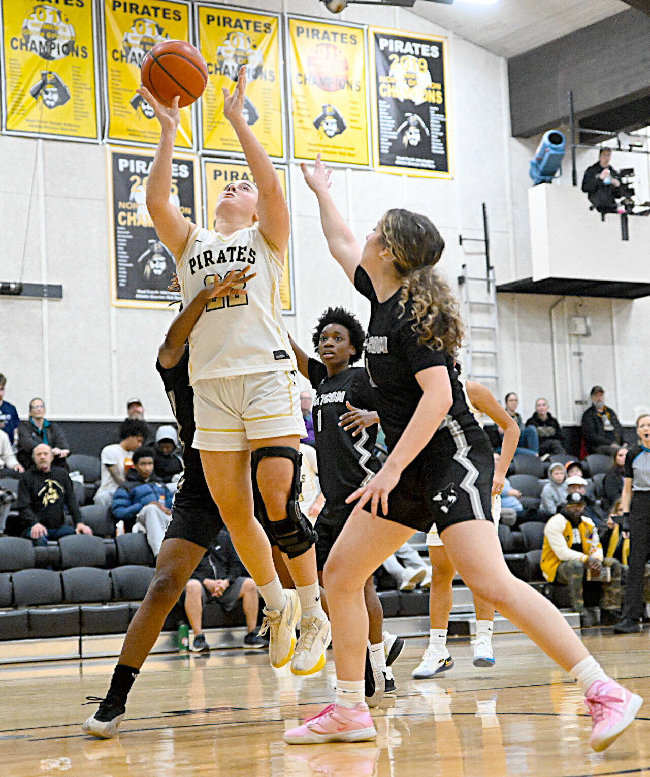 Peninsula Colleges Makena Patrick (22) is surrounded by Whatcom players in the paint Saturday in Port Angeles. Patrick had 16 points and 12 rebounds in a 83-46 Peninsula win. (Jay Cline/Peninsula College)