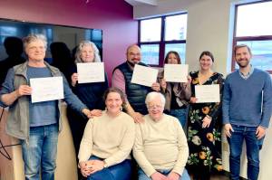The first graduating cohort of EDC Team Jefferson's business advisors training stands with certificates. From left to right are George Sawyer, Kit Malone, Devin Rodriguez, Charlotte Richardson and Justine Wagner. Standing is the EDC's Executive Director David Bailiff. Sitting is the EDC's Program and Finance Manager Phoebe Reid and course instructor Ray Sparrowe.