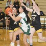 Port Angeles Kenzie Moses is defended by Bainbridge Islands Jordan Gardner (21) and Allie Paulson-Houser (25) on Tuesday in Port Angeles. Moses had a 3-pointer as the Roughriders won 53-46 to remain unbeaten in the Olympic League. (Dave Logan/for Peninsula Daily News)