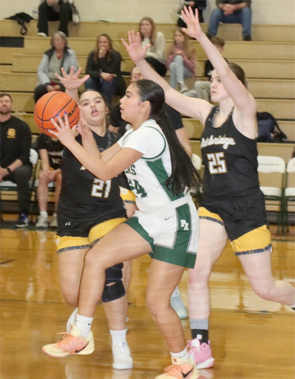 Port Angeles Kenzie Moses is defended by Bainbridge Islands Jordan Gardner (21) and Allie Paulson-Houser (25) on Tuesday in Port Angeles. Moses had a 3-pointer as the Roughriders won 53-46 to remain unbeaten in the Olympic League. (Dave Logan/for Peninsula Daily News)