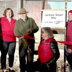 Jackson Smart, center with scissors, cuts the ribbon on Wednesday to officially open the newly remodeled section of the Port Angeles Underground Tour. With Smart are, from left, Julie Hatch, Kara Anderson, Elisa Simonsen, Sam Grello and Johnetta Bindas. (Laurel Hargis)