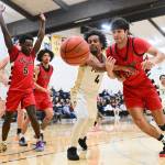 Peninsula Colleges Patrick Odingo (4) battles Olympic for a loose ball Saturday in Port Angeles. The Peninsula men beat Olympic 102-66. (Jay Cline/Peninsula College)