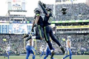 Running back Kenneth Walker III, left, and tight end AJ Barner celebrate during the Seahawks' 31-27 victory over the L.A. Rams at Lumen Field in the NFC Championship Game on Sunday. (Getty Images)