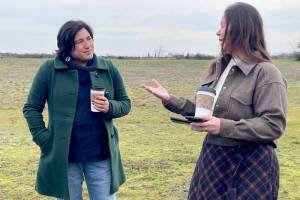 U.S. Rep. Emily Randall, D-Port Orchard, who represents Washingtons 6th Congressional District, left, listens as Lower Elwha Klallam Tribe cultural manager Carmen Watson-Charles explains the history and background of the Tse-whit-zen village located on the west end of Port Angeles Harbor. Randall secured federal funding that will support its preservation. (Paula Hunt/Peninsula Daily News)