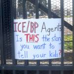 A sign is placed at the entrance of the Border Patrol Station in Port Angeles during a protest on Sunday. (Elijah Sussman/Peninsula Daily News)