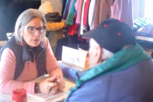 Jefferson County Commissioner Heather Dudley Nollette works to complete the Point In Time Count form with an unsheltered Port Townsend man on Thursday. (Elijah Sussman/Peninsula Daily News)