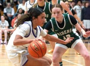 Sequim's Jordyn Julmist dribbles against the defense of Port Angeles' Mikkiah Stevens on Friday night in Sequim. (Emily Matthiessen/for Peninsula Daily News)