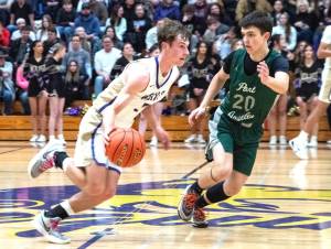 Sequim's Mason Rapelje drives up the court against the defense of Port Angeles' Ashton Gedelman on Friday in Sequim. Rapelje scored 37 points to lead the Wolves to a 71-66 win over the Roughriders. (Emily Mathiessen/for Peninsula Daily News)