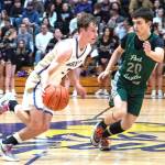 Sequims Mason Rapelje drives up the court against the defense of Port Angeles Ashton Gedelman on Friday in Sequim. Rapelje scored 37 points to lead the Wolves to a 71-66 win over the Roughriders. (Emily Mathiessen/for Peninsula Daily News)