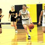 Forks' Bailey Johnson brings the ball up the floor against North Beach on Friday in Forks with teammate Skye Hestand. Johnson, despite a broken wrist, scored 25 points in a 67-25 victory. (Lonnie Archibald/for Peninsula Daily News)