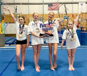 The Klahhane Gymnastics Xcel gold team of, from left, Emily Bair, Abigail Odland, Lorelei Sanders and Zayleigh McCullem finished first at the Freedom Invitational Gymnastics Meet at the Kitsap Pavilion last week. (Klahhane Gymnastics)