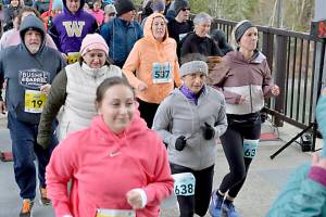 Sammie Sullivan of Kingston (143) leads the pack, including Tanya Woodward of Forks (638)  at the starting line of the 2025 Elwha Bridge Run, which returns Saturday. (Run the Peninsula)