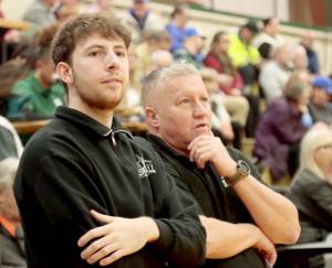 Port Angeles boys head coach Kevin Ruble, right, and volunteer assistant Bryant Hoch watch during pregame Tuesday in Port Angeles before the Roughriders took on defending state champion Bremerton. (Dave Logan/for Peninsula Daily News)
