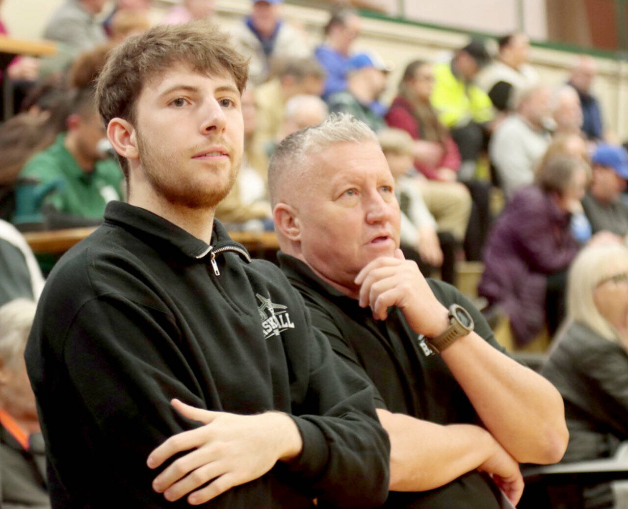 Port Angeles boys head coach Kevin Ruble, right, and volunteer assistant Bryant Hoch watch during pregame Tuesday in Port Angeles before the Roughriders took on defending state champion Bremerton. (Dave Logan/for Peninsula Daily News)