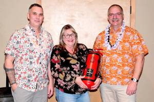 EMT Teresa DeRousie, center, was recognized for her long service to Clallam County Fire District 2. Presenting the award were Deputy Fire Chief Kevin Denton, left, and Chief Jake Patterson. (Clallam County Fire District 2)