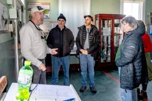 Dan Willis of Port Townsend, a docent at the Point Wilson Lighthouse at Fort Worden State Park, conducts a tour for interested visitors on Thursday. The lighthouse was built in 1878 when Congress approved $8,000 for the light and foghorns. Although the facility is still an active U.S. Coast Guard station, the equipment is monitored and operated remotely and no keepers are present. Regular tours on Saturdays and Sundays will resume in May. (Steve Mullensky/for Peninsula Daily News)