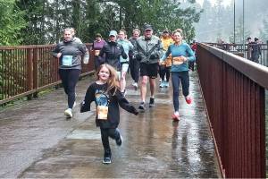 Runners in the Run The Peninsula's Elwha Bridge Run take off into the rain Saturday morning. (Pierre LaBossiere/Peninsula Daily News)