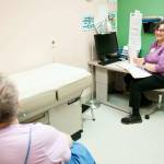 Kathi Gunn, right, a chronic healthcare nurse practitioner for the Dungeness Valley Health and Wellness Clinic, speaks with a patient. This year, thanks to volunteers and donors, the clinic will mark 25 years of providing free healthcare services to those who are uninsured or under-insured. (Austin James)