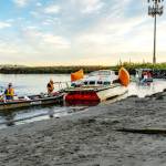 Port of Port Townsend Harbormaster Kristian Ferrero, right, watches as a crew from Seattle Global Diving and Salvage work to remove a derelict catamaran that was stuck in the sand for weeks on a beach at the Water Front Inn on Washington Street in Port Townsend. The boat had been sunk off of Indian Point for weeks before a series of storms pushed it to this beach last week. (Steve Mullensky/for Peninsula Daily News)