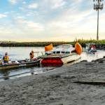 Port of Port Townsend Harbormaster Kristian Ferrero, right, watches as a crew from Seattle Global Diving and Salvage work to remove a derelict catamaran that was stuck in the sand for weeks on a beach at the Water Front Inn on Washington Street in Port Townsend. The boat had been sunk off of Indian Point for weeks before a series of storms pushed it to this beach last week. (Steve Mullensky/for Peninsula Daily News)