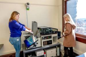 Jefferson County Auditor Brenda Huntingford, right, watches as clerk Ronnie Swafford loads a stack of ballots that were delivered from the post office on Tuesday into a machine that checks for signatures. The special election has measures affecting the Port Townsend and Brinnon school districts as well as East Jefferson Fire Rescue. (Steve Mullensky/for Peninsula Daily News)