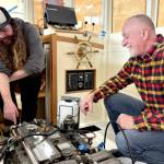 Northwest School of Wooden Boatbuilding Board President Richard Schwarz gets a rundown of the systems installed in a lobster boat built on campus by Iain Rainey, a recent graduate and current Marine Systems Prothero intern. (Northwest School of Wooden Boatbuilding)