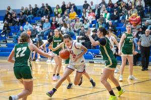Steve Mullensky/for Peninsula Daily News
East Jeffersons Penina Vailolo drives around a pair of Vashon Pirates on her way to the rim during the Rivals 55-30 Nisqually League win at Chimacum High School on Thursday.