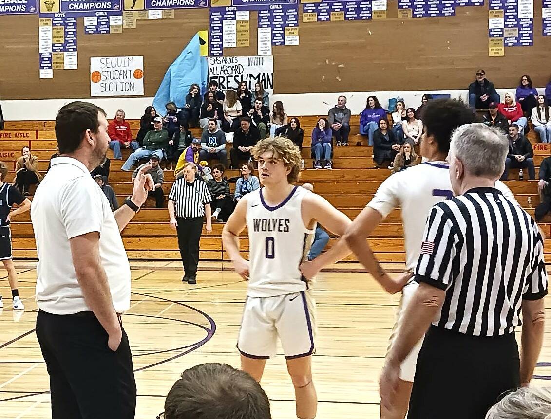 Sequim coach Craig Brooks talks to Zeke Schmadeke (0) and Solomon Sheppard during the game Saturday in Sequim. (Pierre LaBossiere/Peninsula Daily News)