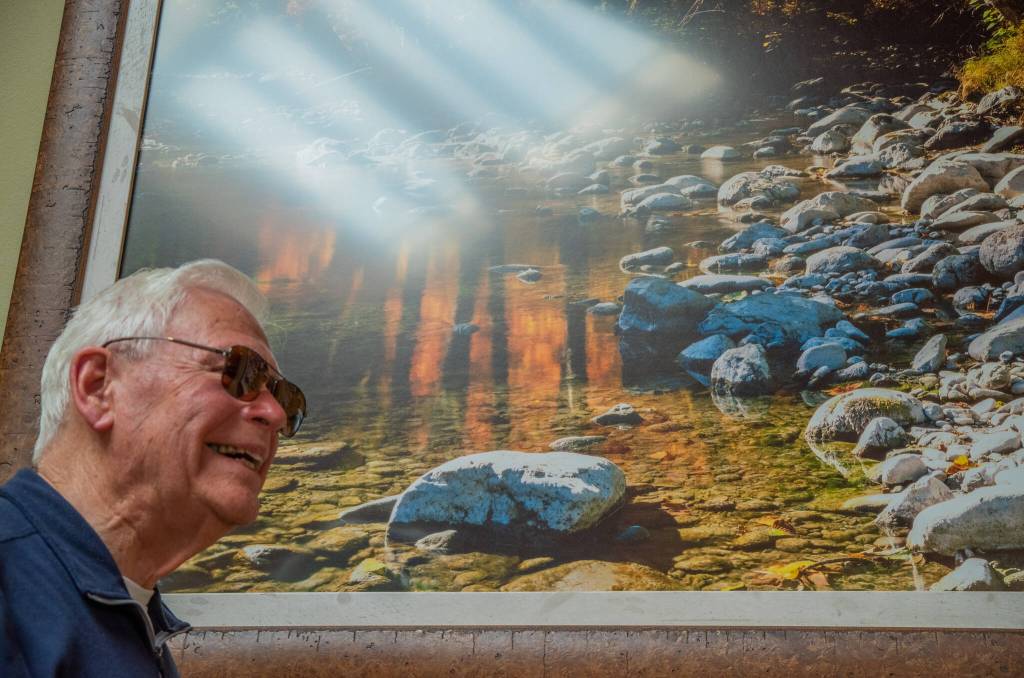 Sequim Gazette file photo by Emily Matthiessen/
Photographer Ross Hamilton, pictured in 2023, reflects on his years of capturing the beauty of the Olympic Peninsula prior to a presentation at the Lodge at Sherwood Village. Several of his photos are displayed throughout the building.