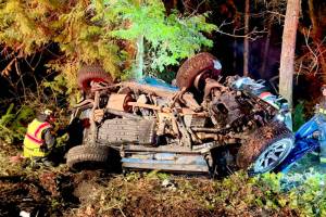 Emergency responders work at the scene Sunday night after a driver crossed the centerline just east of Sequim and collided head-on with another vehicle. One person died and two others were injured in the incident. (Clallam County Fire District 3 via Facebook)