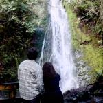 Jada Easterly of Utah and her partner Kaeden Warnberg-Lemm of Minnesota were on a national park trek and found Madison Falls west of Port Angeles. The falls are located at the park entrance up the Elwha River valley on Olympic Hot Springs Road on a wheelchair-accessible, 500-foot trail. (Dave Logan/for Peninsula Daily News)