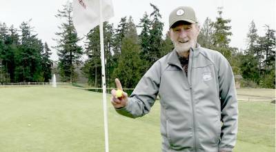 Everett Thometz celebrates his hole-in-one at hole No. 8 at the Cedars at Dungeness.