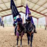 Senior salute to graduating seniors Katelynn Sharpe, carrying a sponsor flag, left, and team captain Asha Swanberg, carrying the Sequim Team flag.