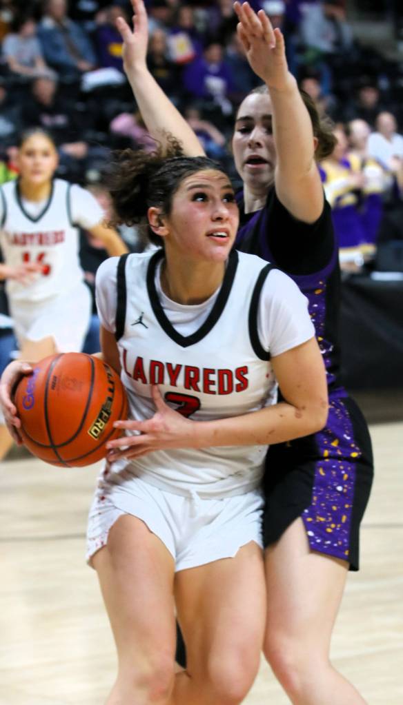 Roger Harnack/Cheney Free Press Neah Bays Angel Halttunen eyes the basket while guarded by a Pateros Nannies player during the Red Devils state quarterfinal win on Thursday night at the Spokane Veterans Arena.