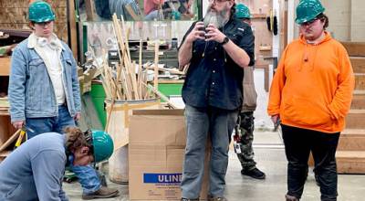 Port Angeles High School CTE teacher Paul Arndt, center, is conducting a construction class for students who are building the subfloor and framing for a tiny home that will become part of 4PAs Touchstone Campus transitional housing. The class is part of the statewide Core Plus program, which provides hands-on training for careers in the skilled trades. (Paula Hunt/Peninsula Daily News)