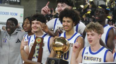 The Bremerton Knights hold their state championship trophy after beating the RA Long Lumberjacks 45-43 in the 2A boys state basketball championship Saturday at the Yakima SunDome. (Luke Caputo/Kitsap News Group)