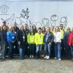 Sequim Food Bank board members commemorate the transition between outgoing executive director Andra Smith and new director Jen Colmore. Colmore first worked as a volunteer and then the facilitys community engagement coordinator. (Matthew Nash/Olympic Peninsula News Group)
