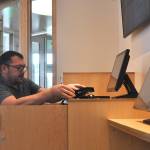 Damien Hare, systems administrator for the North Olympic Library System, readies the Sequim Librarys new self-checkout stations for its reopening on Saturday. (Matthew Nash/Olympic Peninsula News Group)