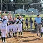 Port Angeles Abby Rudd is welcomed at home by her teammates after belting a two-run home run against Kingston on Friday. (Dave Logan/for Peninsula Daily News)