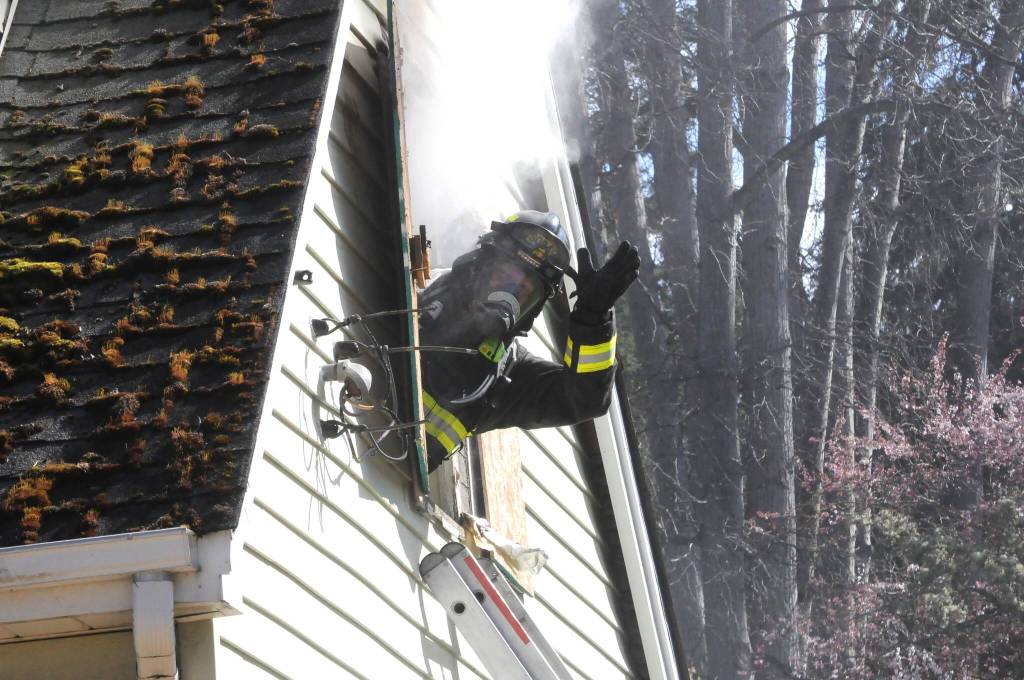 Community Paramedic Mark Karjalainen waves from a window as he awaits a training session to begin on March 21. (Matthew Nash/Olympic Peninsula News Group)