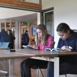 Ruth Scheet and Violet Bays read graphic novels together at a table together inside the renovated Sequim Library on March 21. (Matthew Nash/Olympic Peninsula News Group)