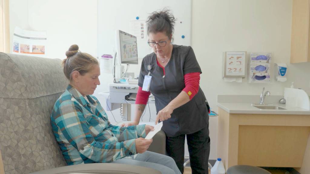 Kidney patient Gabriele Ellis of Sequim receives instruction from Lara Severn, a nurse who manages Northwest Kidney Centers peritoneal dialysis program for the region. After receiving training from Severn at the nonprofits Port Angeles facility, Ellis was able to manage her own dialysis at home. (Northwest Kidney Centers)