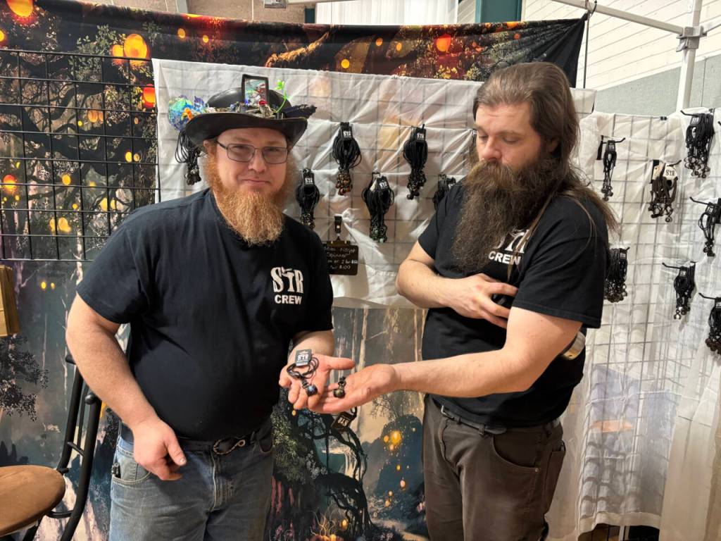 Blacksmiths Stryker Gooch, left, and Brian Townsend of the Port Townsend-based Stryker Forge show off the medieval fidget spinner jewelry in their booth at the Port Angeles Craft Mania event continuing through 6 p.m. today at the Vern Burton Community Center, 308 E. Fourth Street, Port Angeles. Gooch is a former winner of the History Channels Forged in Fire smithing competition show. (Kelley Lane/Peninsula Daily News)