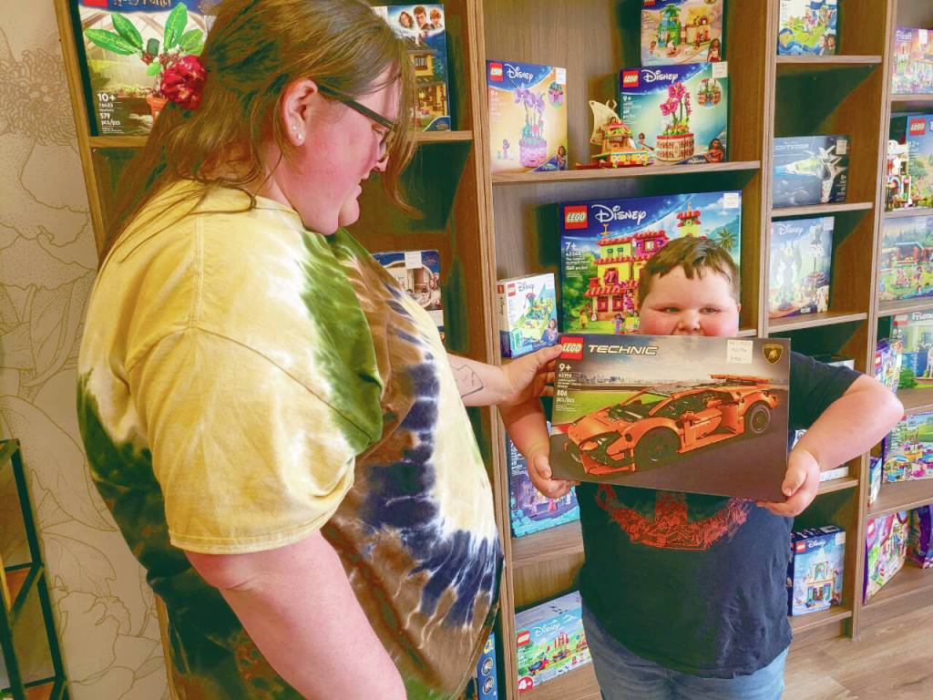 Shandee Scull, left, looks at a set her son, 7-year-old Wyatt Scull, holds up for her Thursday at Olympic Bricks in Port Angeles. (Emily Hanson/Peninsula Daily News)