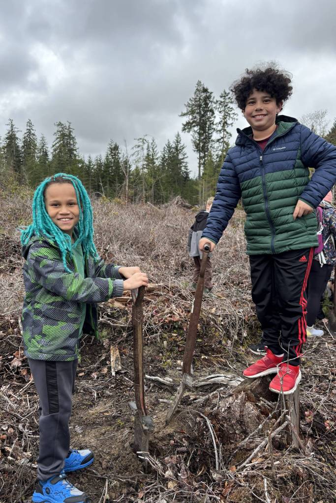 Jazzy Haabala and Ezekiel Hicks search for spots to plant trees on March 25. (Matthew Nash/Olympic Peninsula News Group)
