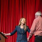 Brita Altig, née Guthrie, greets her father Jim Guthrie as he goes onstage at the Port Townsend High School auditorium on Saturday to receive the Alumni Inductee Award and to be inducted into the PTHS Alumni Hall of Fame. (Steve Mullensky/for Peninsula Daily News)