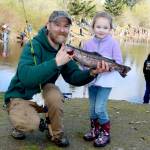 Dave Logan/for Peninsula Daily News
Morgan Duffy of Port Angeles, has her dad Joshua Duffy hold the fish she caught at the 2025 Kids Fishing Derby at Lincoln Park. The 2026 edition of the derby is set for Saturday at Lincoln Park. Sequims Kid Fishing Day is set for April 18 at Carrie Blake Park.