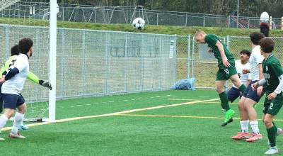 Port Angeles Matthew Miller heads the ball for a goal against Forks on Saturday at the Monroe Playfield. Miller finished with a hat trick to give him 74 career goals, breaking Millie Longs school record for boys or girls soccer. (Dave Logan/for Peninsula Daily News)
