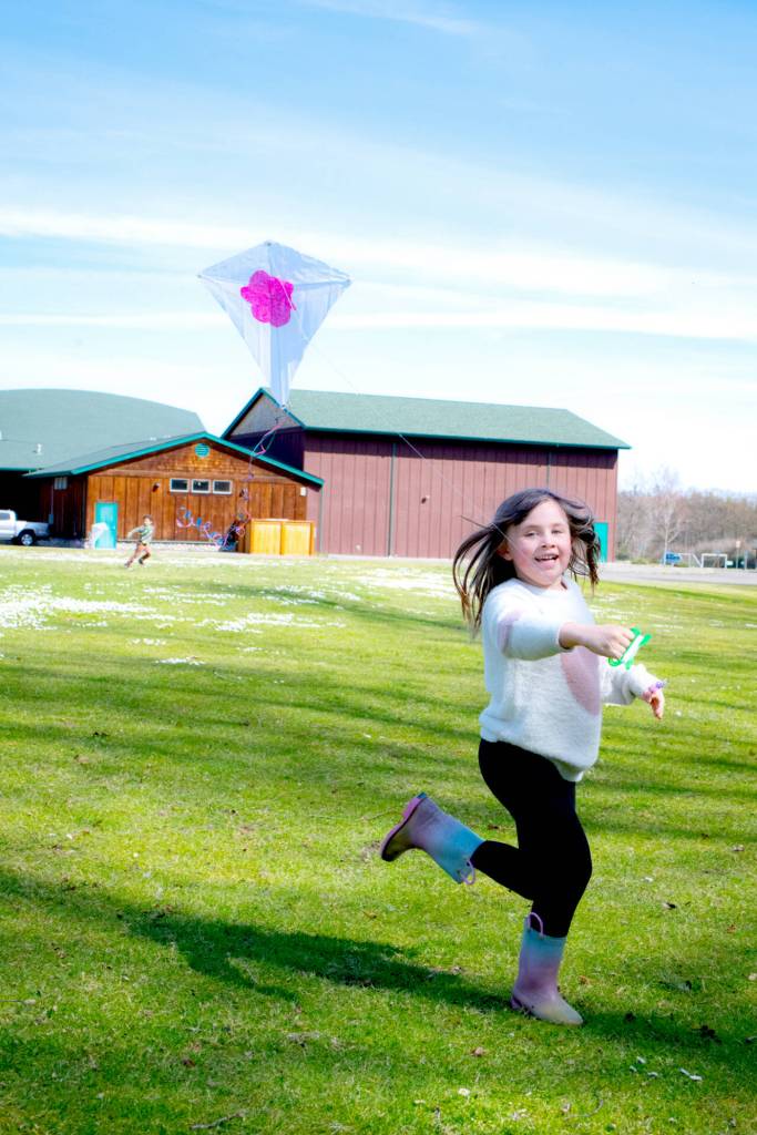 Claire Packer, 6, of Sequim, flies a kite she made at the Friendship Garden open house event at Carrie Blake Community Park. (Monica Berkseth/Olympic Peninsula News Group)