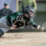 Port Angeles Carson Waddell dives to make a play at the plate against North Kitsap on Friday. The Roughriders won 6-5 in extra innings. (Jeff Halstead/for Peninsula Daily News)